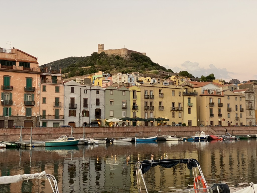 Bosa rooftops, river, and sea from above