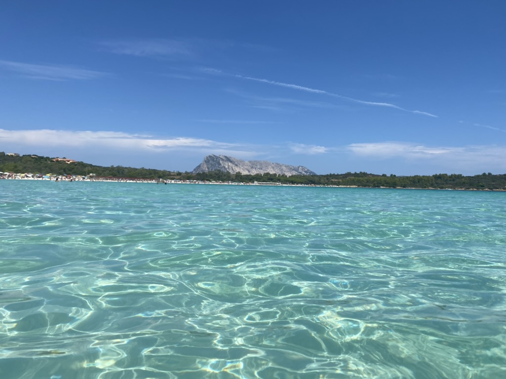Turquoise water at Cala Brandinchi with Tavolara in the distance