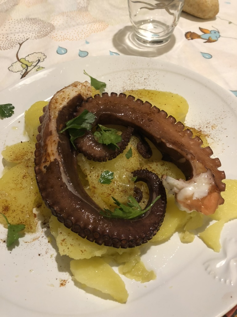 Octopus and potatoes served with olive oil