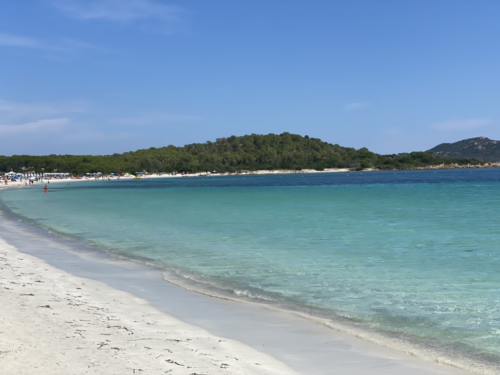 Clear water and pale sand at Lo Impostu