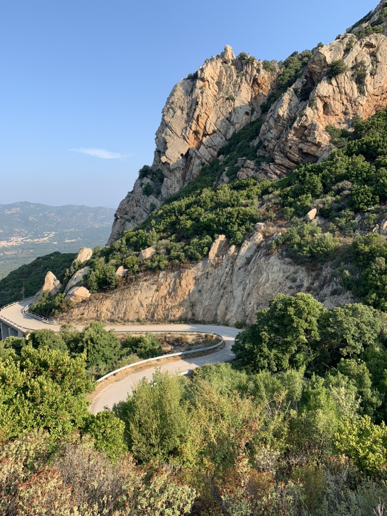 Mountain road bend through granite landscape